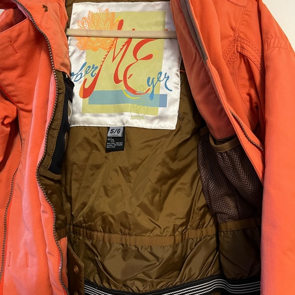 Obermeyer ski jacket in orange with brown lining. Lots of pockets, zipper front. - Picture 3 of 4